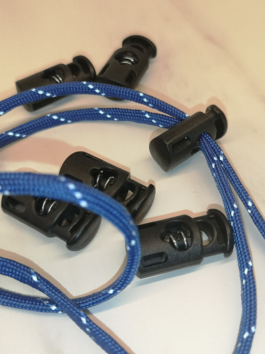 Blue braided lanyard with black plastic toggle on a beige background 